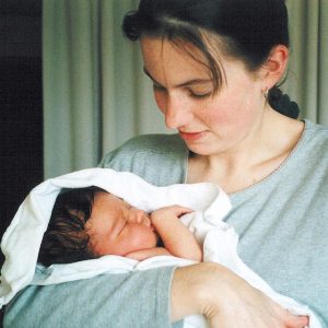 Jenn holding Val's newborn daughter