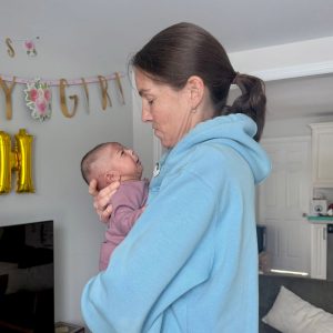 Jenn with Reema's hungry infant daughter